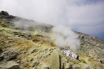 Fototapeta na wymiar Volcano crater of the volcano with sulphurous fumes, Aeolian Islands, Messina, Sicily, Italy
