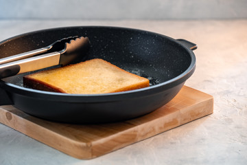 Crispy white bread toasters with butter on a wooden board
