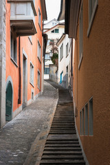 Street alley with stairs and colorful buildings in Zurich