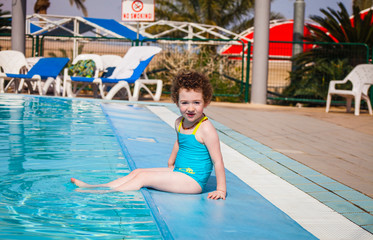 Cute little girl in an open air swimming pool
