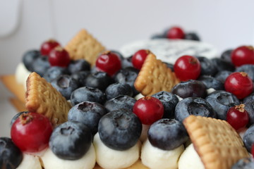 Luxury cake with berries and cream with smart decoration.
