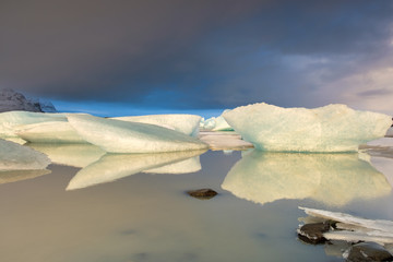 Iceland in winter: stunning icebergs reflected in a lake