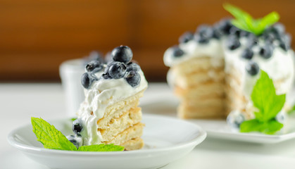Delicious pancakes with sweet creamy yogurt and fresh berries with mint