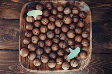Macadamia in a bamboo bowl. Useful nuts. The key for nuts and healthy food.