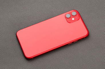 Smartphone on a gray surface. A popular smartphone close-up.
