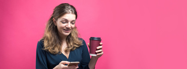 Obraz na płótnie Canvas Glamor woman with a drink of coffee on a pink background.