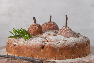 Delicious spice cake with pear, ginger and cinnamon on a white kitchen counter.