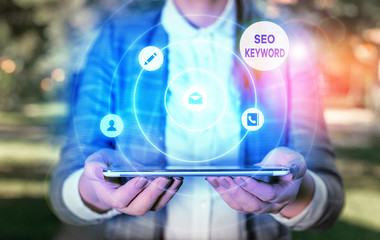 Writing note showing Seo Keyword. Business concept for phrases in your web content that help...