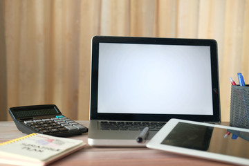 laptop, notepad and calculator on office desk 