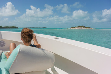 Woman enjoys the Bahamas landscape on a boat in holidays