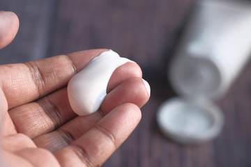 Close up of face cream on person hand 