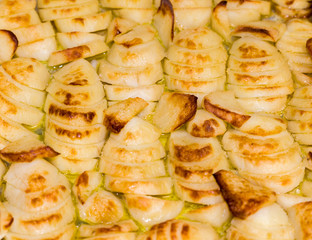 Baking potato chips on baking sheet in the oven.