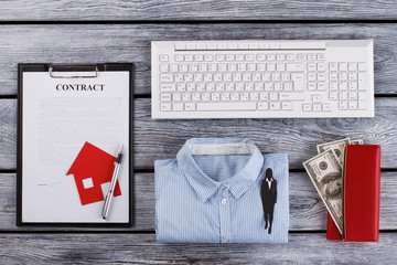 Real estate contract and female's office selection. Stationery and money on background. Ppaer women's figure. Office concept.