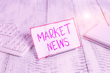 Conceptual hand writing showing Market News. Concept meaning Commercial Notice Trade Report Market Update Corporate Insight Notepaper on wire in between computer keyboard and sheets