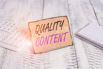 Text sign showing Quality Content. Business photo showcasing content that delivers value and consists of great writing Notepaper stand on buffer wire in between computer keyboard and math sheets