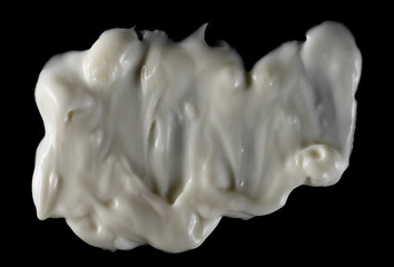 Mayonnaise isolated on black, top view with clipping path