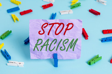 Word writing text Stop Racism. Business photo showcasing end the antagonism directed against someone of a different race Colored clothespin papers empty reminder blue floor background office pin