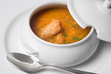 Chicken soup in white bowl on white background.