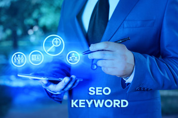 Writing note showing Seo Keyword. Business concept for phrases in your web content that help...