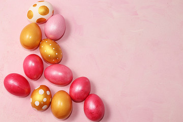 Decorated golden easter eggs on a pink background. Minimal holiday concept. Happy easter...