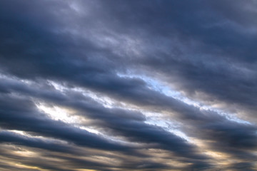 Background of dramatic sky with dark clouds. Sky before a thunder-storm. Abstract natural sky background.