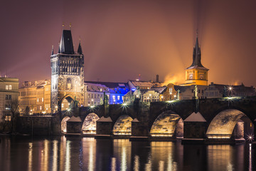 Fototapeta na wymiar Prague at night, Charles Bridge and its tower from across the river.