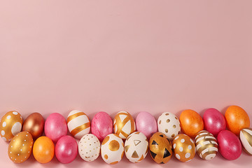 Decorated golden easter eggs on a pink background. Minimal holiday concept. Happy easter background. Creative painting of eggs at home, the idea of simple drawings for coloring, a place for text, 