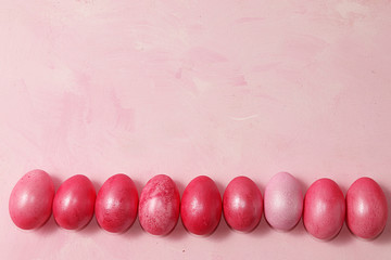 Decorated golden easter eggs on a pink background. Minimal holiday concept. Happy easter...