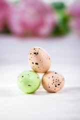 Naklejka na ściany i meble Happy Easter. Three pastel Easter eggs on a white background, copy space