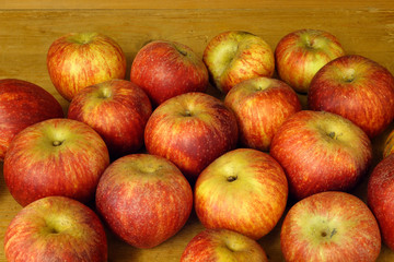 Selection of red apples on wooden background