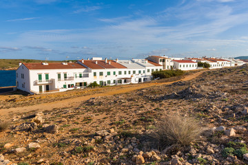 Fototapeta na wymiar Whitewashed houses in beautiful Fornells village in Menorca. Spain