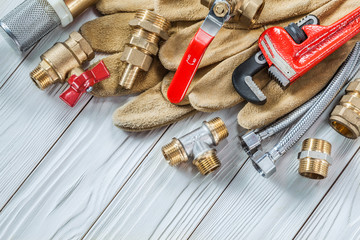 plumbing tools pipe fixtures and walves pipewrench on wooden boards