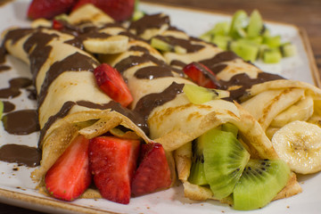 Healthy crepes with fruits, banana, kiwi and strawberry. Healthy french breakfast