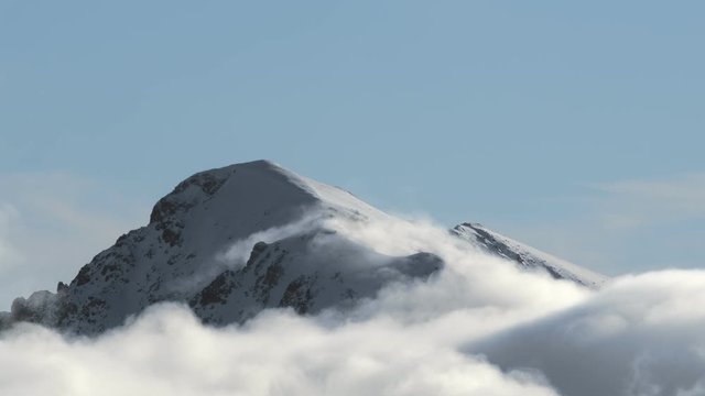 4K timelapse of mountain peak with clouds on the sky