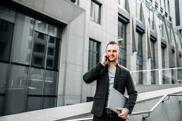 Modern young and creative businessman with laptop