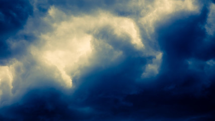 Naklejka na ściany i meble Dramatic stormy dark blue cloudy sky, natural photo background
