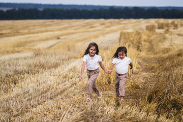 Little girl running across the sunny field.