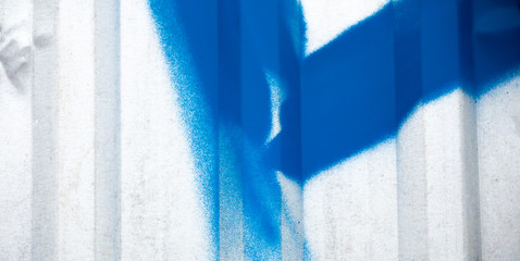 the texture of the metal fence from the profile with blue graffiti