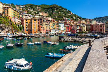 Boats along pier in small harbour of Camogli, Italy.