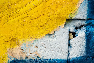 old yellow cement and blue brick wall. Beautiful concrete stucco. painted cement. background texture wall