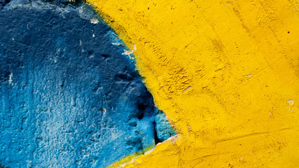 old blue and yellow cement wall. Beautiful concrete stucco. painted cement. background texture wall