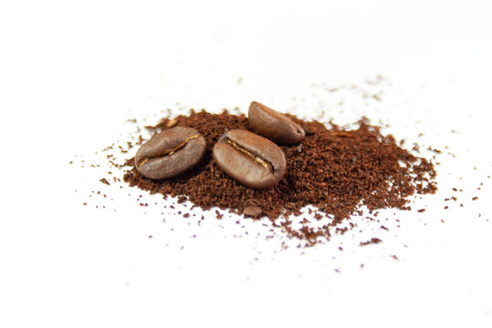 Coffee beans and ground coffee on a white background © Monika