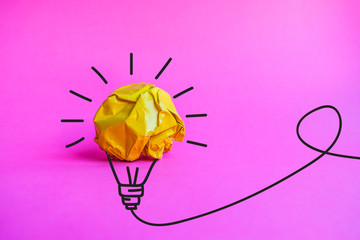Paper make to light bulb for idea power energy concept on pink background.