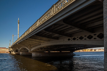 he embankment of the Neva and Blagoveshenskiy bridge with remnants of ice bright warm spring day in March