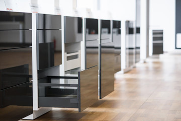 Opened kitchen drawer with cutlery tray. Two drawers are hide behind the high front. Smart storage solution.