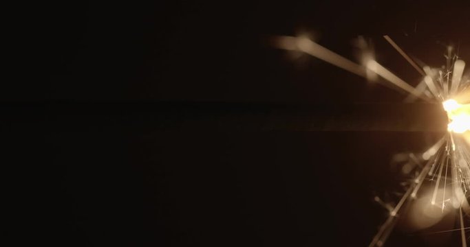 Slow motion footage of sparkler in the dark