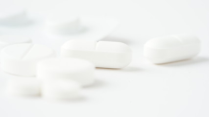 White medical pills coronavirus, white background. Closeup photo of medical preparations with copy spaes.Macro photo.