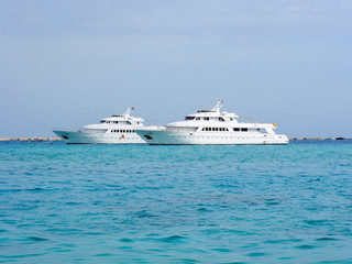 Yachts sailing on azure sea water