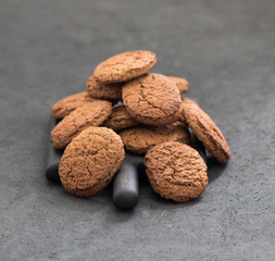 Oatmeal cookies scattered on a dark background