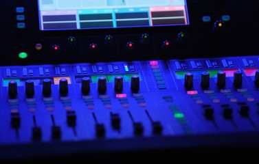 audio mixer in blue light lamps faders and touchscreen